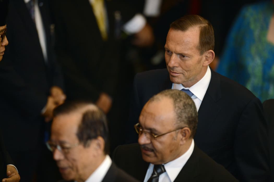 Peter O'Neill between Australian Prime Minister Tony Abbott and former Japan Prime Minister Yasuo Fukuda at the swearing in ceremony of Indonesia's Joko Widodo.