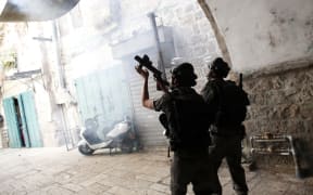 A picture taken on September 15 shows Israeli police using stun grenades to disperse Palestinian demonstraters in al-Wad street in the Muslim quarter of Jerusalem's Old City.