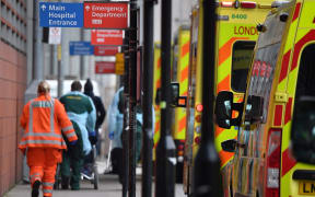 Paramedics unload a patient from an ambulance outside the Royal London Hospital in east London on January 8, 2021.