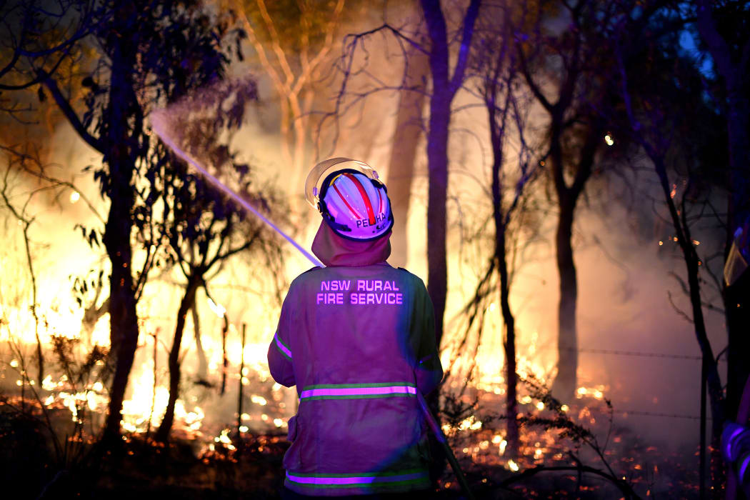 A firefighter protecting a residential area from bushfires north of Sydney on 7 December, 2019. Experts said the last Australian bushfire season arrived earlier and with more intensity because of climatic changes and prolonged drought.