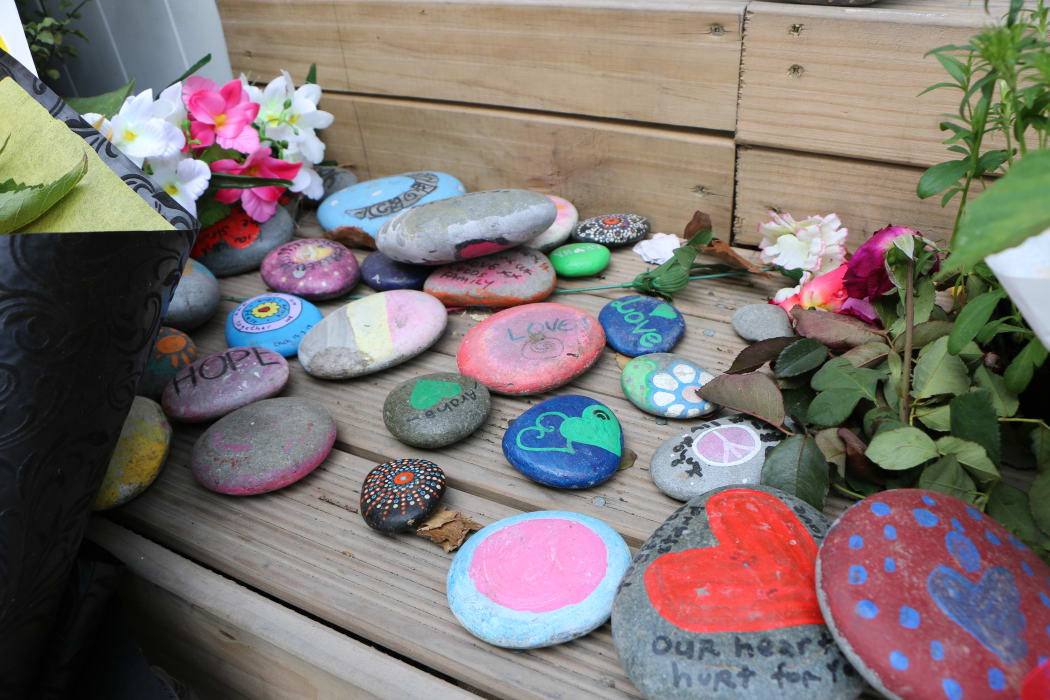 People have left rocks with messages of support and drawings at the Linwood Mosque entrance on the one-year anniversary since the shootings.
