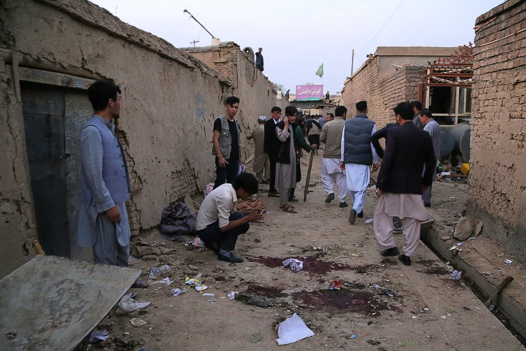 Residents gather near the site following the suicide bombing.