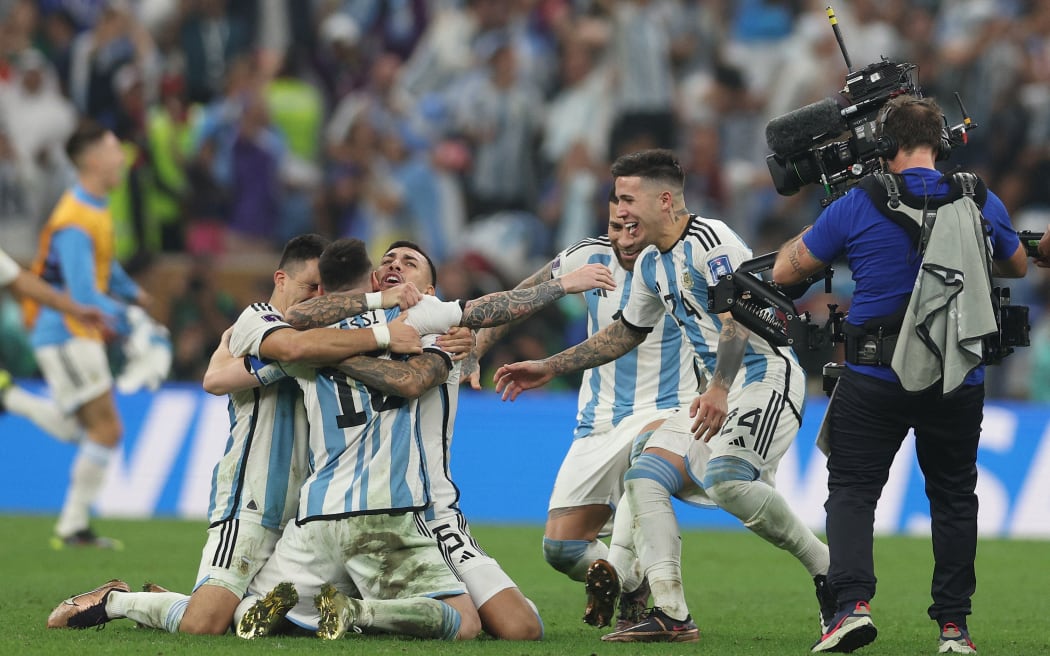 Argentina's forward #10 Lionel Messi  celebrates with teammates after Argentina won the Qatar 2022 World Cup final football match between Argentina and France at Lusail Stadium in Lusail, north of Doha on December 18, 2022.