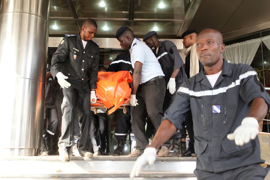 Officers evacuate bodies of victims from the Radisson Blu hotel in Bamako