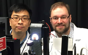 Yingzhuang Ma, left, and Jonathan Halpert are measuring the performance of a solar cell.