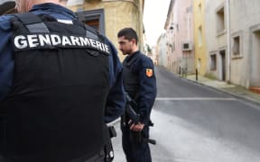 Armed police patrol the street in southern Montpellier after four people suspected of planning a terror attack were arrested.