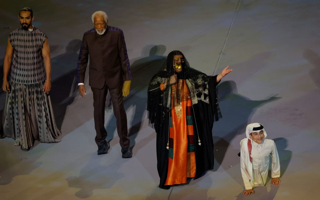 US actor Morgan Freeman, second left, Qatari singer Dana al-Fardan (second right), and Qatari YouTuber Ghanim al Muftah, right, perform during the opening ceremony of the Fifa World Cup in Qata, 20 November 2022.