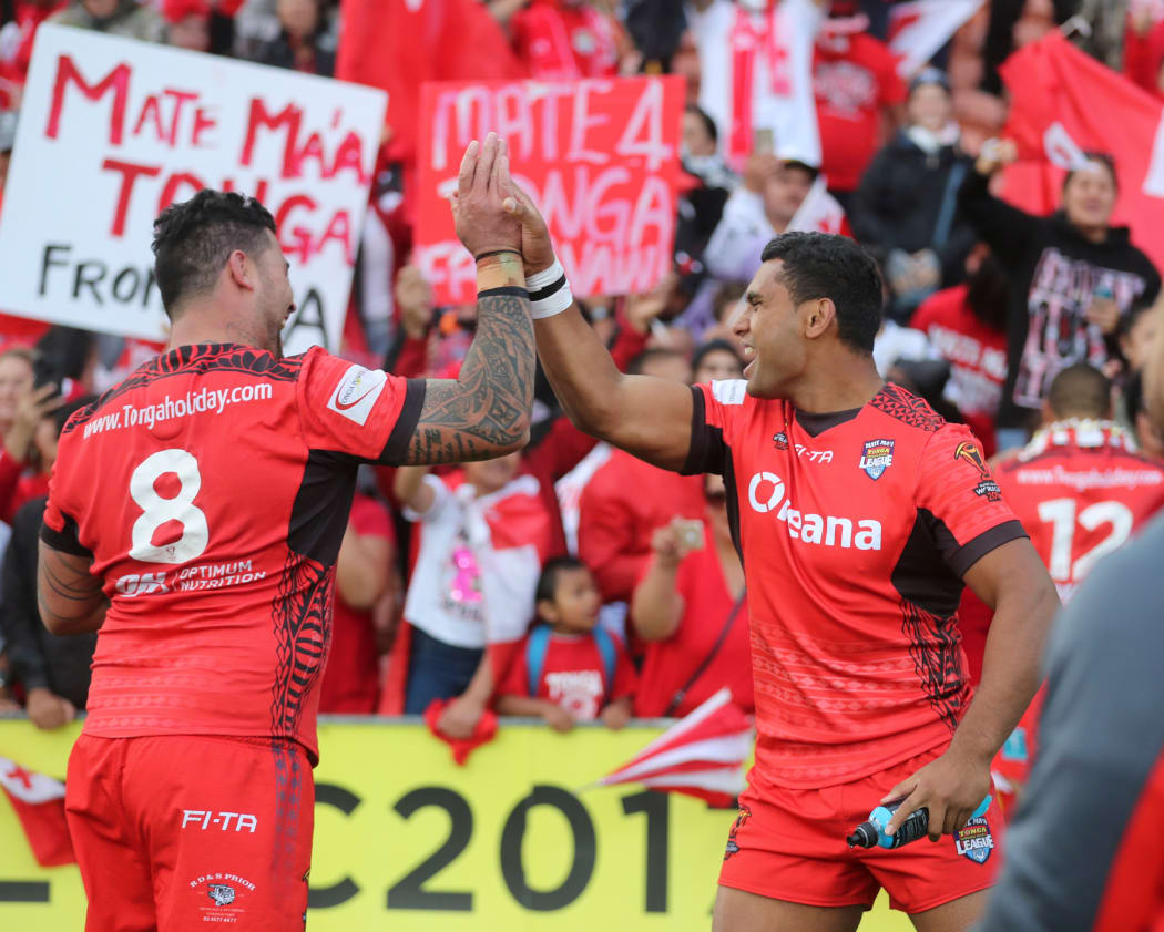 Tonga's Andrew Fifita and Tevita Pangai Junior celebrate their upset win over the Kiwis at the 2017 World Cup.