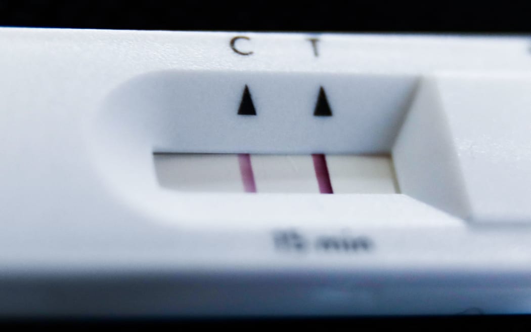 A positive result of rapid antigen test is seen in this illustration photo