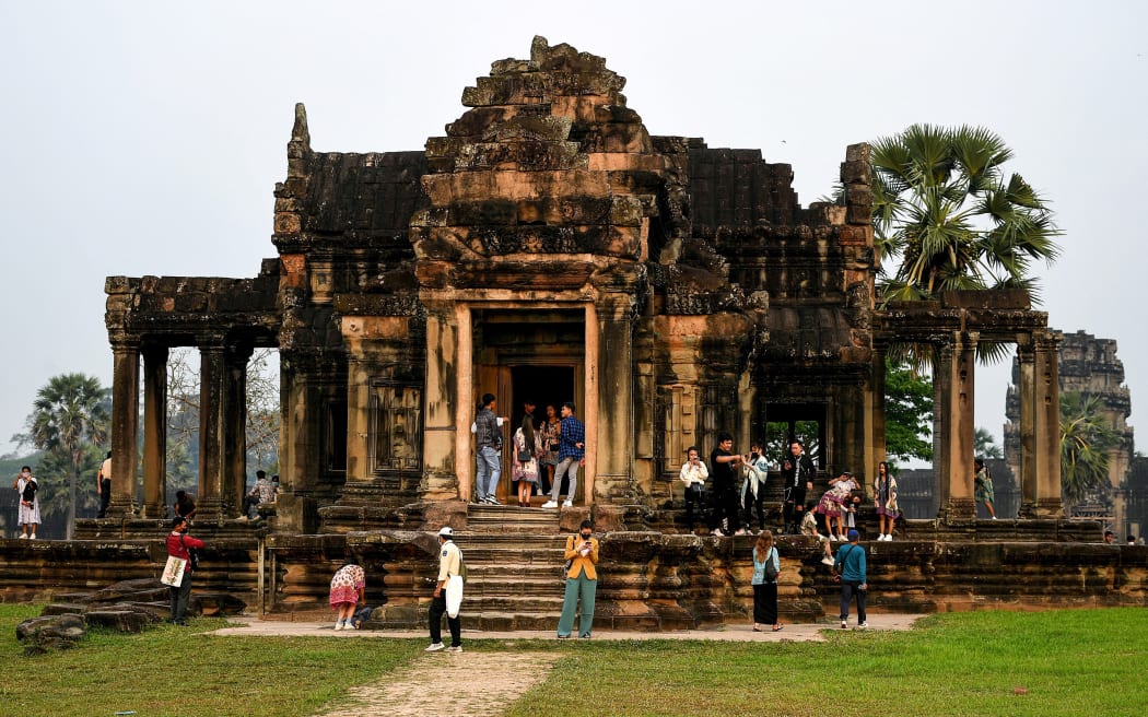 This picture taken on 8 April 2022 shows tourists visiting the Angkor Wat temple complex, a UNESCO World Heritage Site, in Siem Reap province.