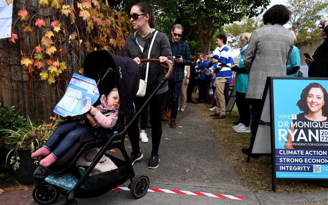 Unmasked voters queue to vote at a pre-polling centre in Melbourne on 12 May.