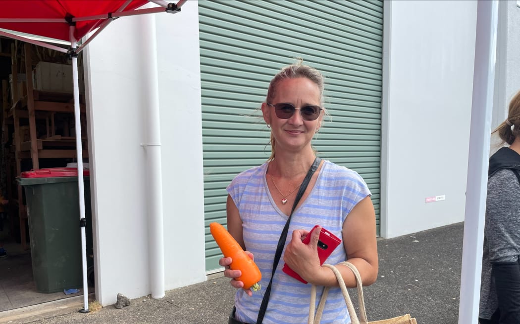 A shopper with a bag full of Perfectly Imperfect produce.