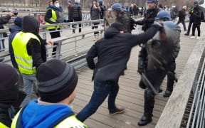 A video grab shows Christophe Dettinger fighting with riot police during a demonstration by "Gilets Jaunes" anti-government protestors.