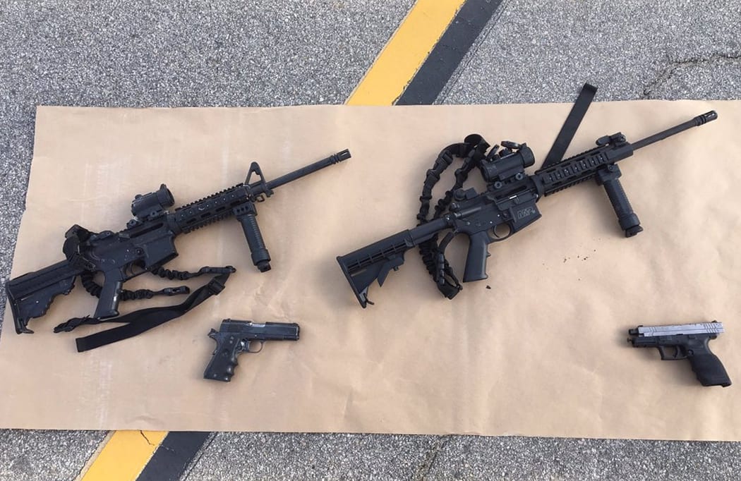 This image obtained from the San Bernardino County Sheriff, shows weapons carried by the suspects