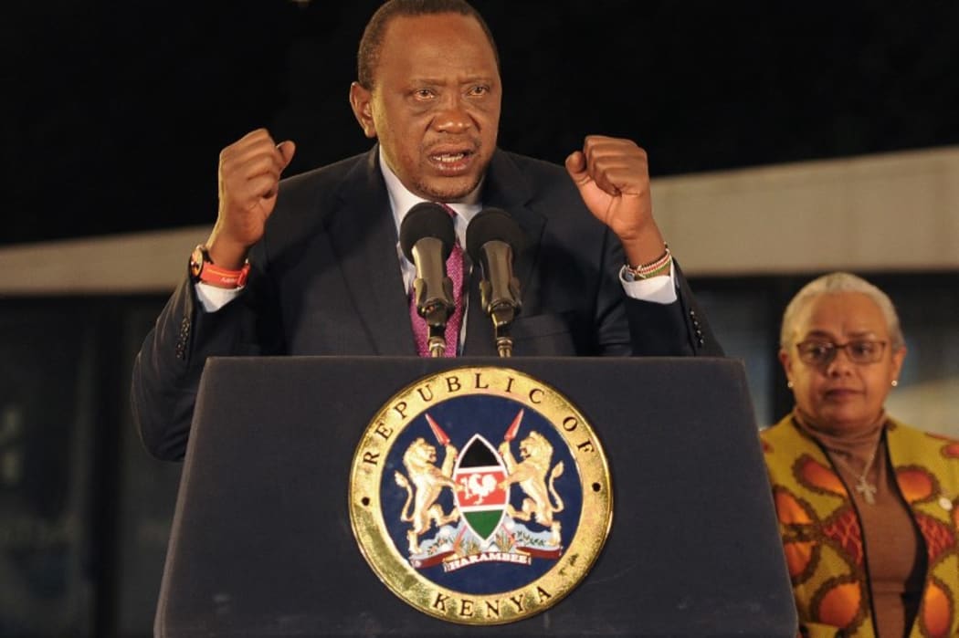 Kenya's President Uhuru Kenyatta, flanked by his wife Margaret Gakuo Kenyatta, speaks following the Electoral Commission's official announcement of the election results.