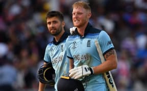 England's Ben Stokes (R) reacts in frustration as he loeaves the pitch with England's Mark Wood ahead of a 'super over' during the 2019 Cricket World Cup final between England and New Zealand at Lord's Cricket Ground July 14, 2019.