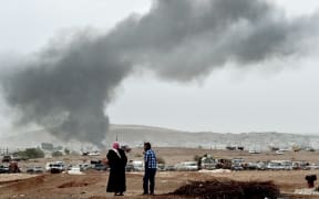 Smoke rises from the Syrian town of Kobane after air strikes yesterday.