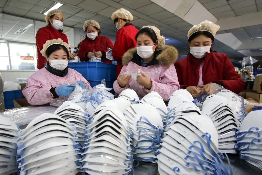 Workers producing face masks at a factory in Handan in China's northern Hebei province, on 22 January 2020.