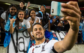 Fiji's Jarryd Hayne celebrates with fans after Fiji's win over the Kiwis