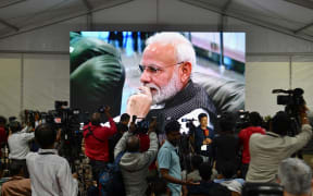 India's Prime Minister Narendra Modi is seen on a TV screen as he watches the live broadcast of the attempted moon landing of spacecraft Vikram Lander of Chandrayaan-2.