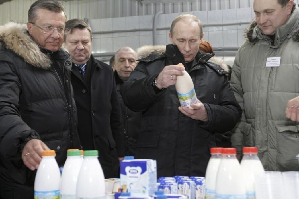 Russian president Vladimir Putin looking at Russian milk