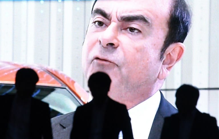 An image of Carlos Ghosn on a large screen in Tokyo
