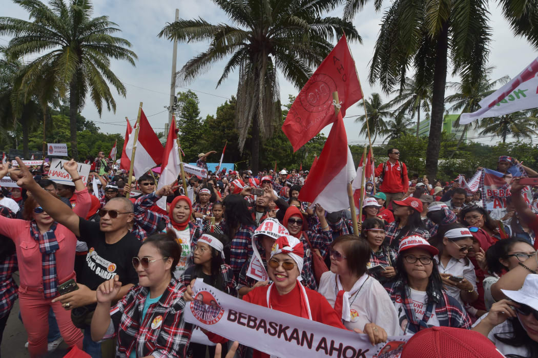 Supporters of Jakarta governor Basuki Tjahaja Purnama, also known as Ahok, dance outside the North Jakarta court.