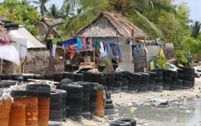 Villagers have resorted to using tires and barrels for protection from the sea