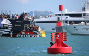 A seal has secured one of the best seats in the house on a channel marker at the edge of the course.