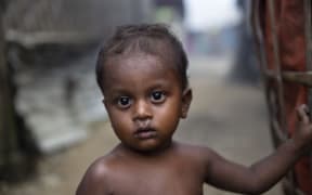 A Rohingya Muslim child stand outside a shelter at the Thet Kel Pyin camp in Rakhine state.