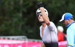 New Zealand's Samuel Gaze gestures in the transition area after suffering a puncture.