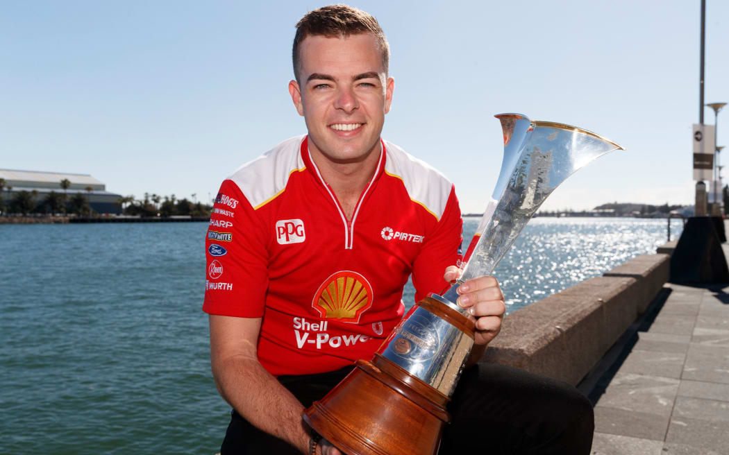 Kiwi driver Scott McLaughlin with the Supercars championship trophy after his 2018 title triumph.
