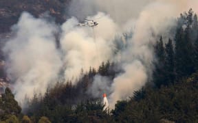 A helicopter battles the fire.