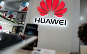 A Huawei logo is displayed at a retail store in Beijing.