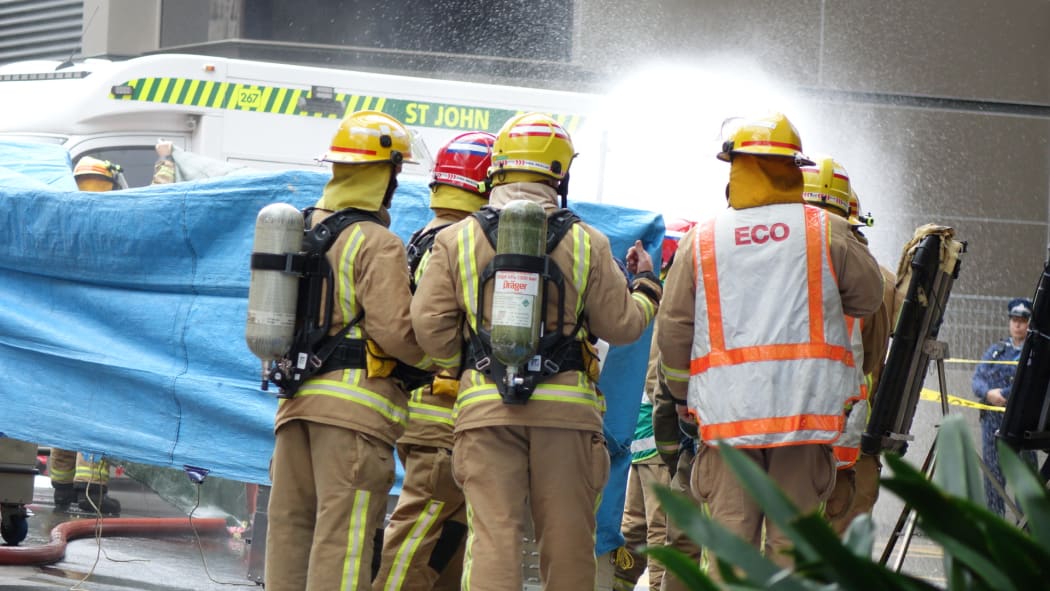 A decontamination shower underway outside the Hotel Grand Chancellor in Auckland central