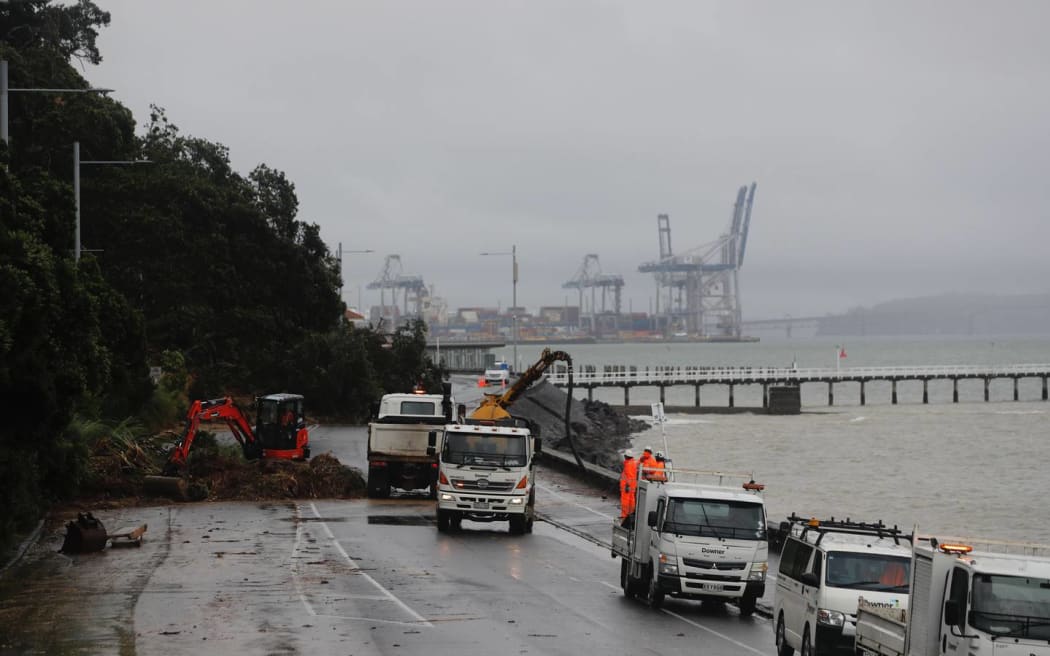 Workers clear a large slip on Tamaki Drive between Okahu Bay and Mission Bay.
