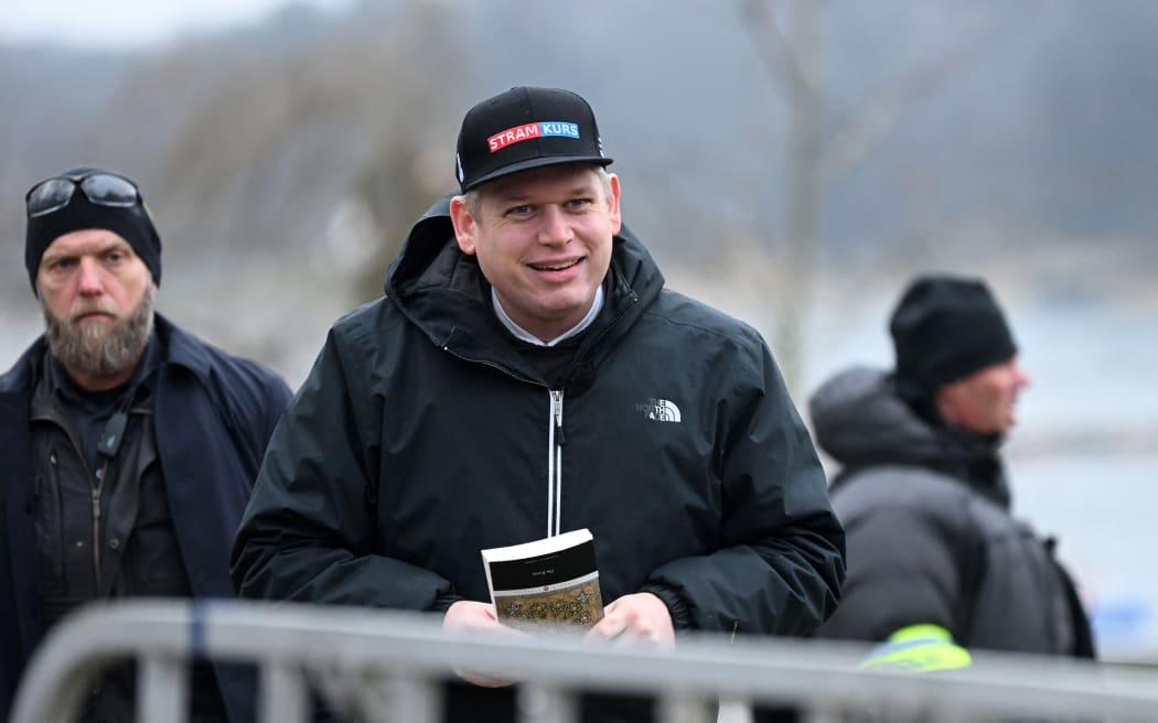 The leader of the far-right Danish political party Stram Kurs, Swedish-Danish politician Rasmus Paludan is pictured while holding an edition of The Quran while staging a protest outside the Turkish Embassy in Stockholm, Sweden, on January 21, 2023.