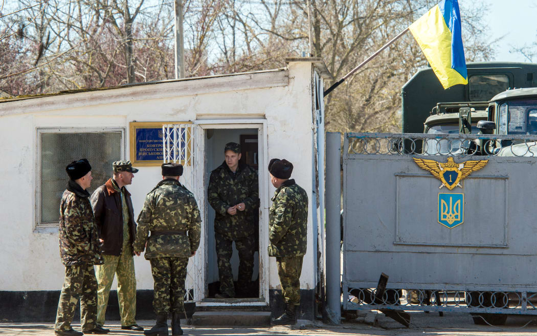 Ukrainian pilots and soldiers gather at the air base entrance in Fedorovka, Saky district, Crimea, on March 22, 2014.