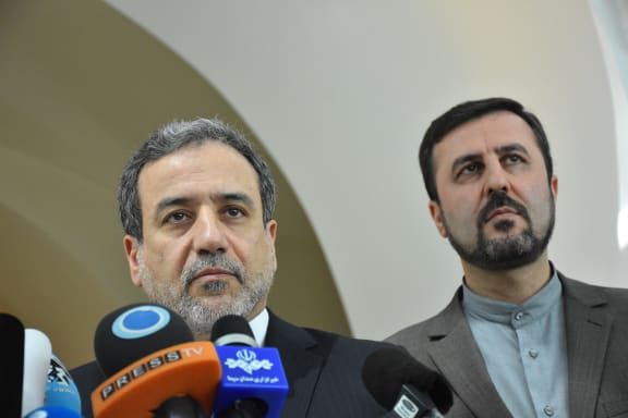 Iranian Deputy Foreign Minister Abbas Araghchi (left) makes a speech after attending Joint Comprehensive Plan of Action meeting on Iran's nuclear program in Vienna, Austria on 28 July, 2019.