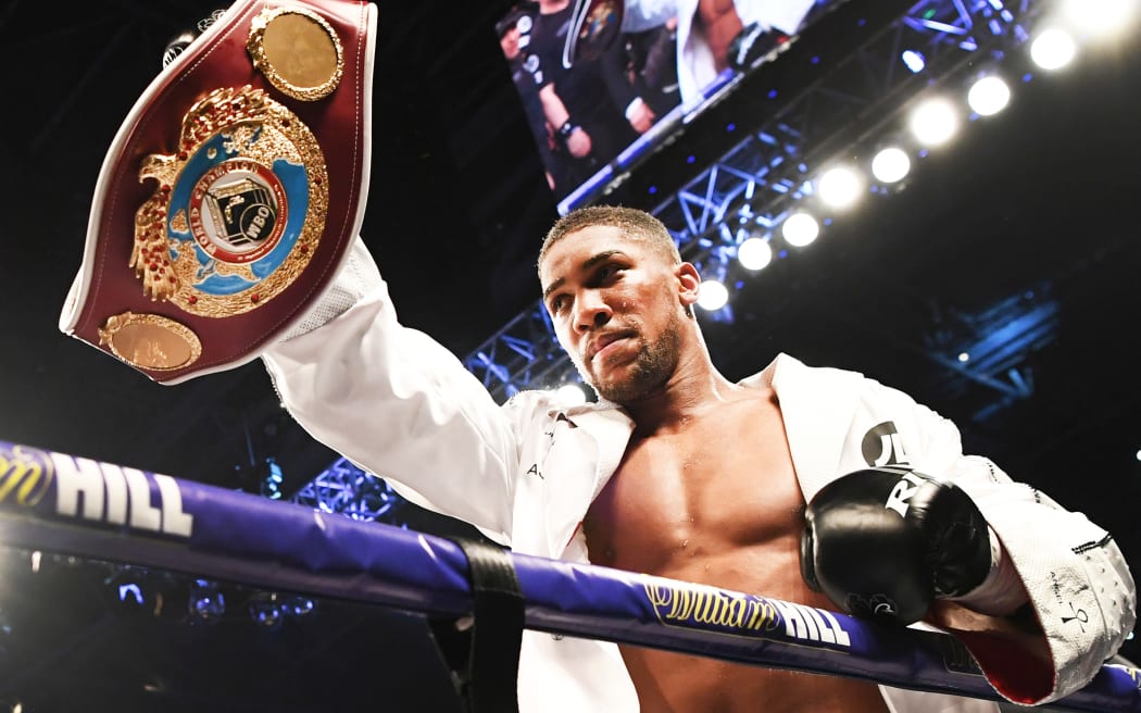 Anthony Joshua holds up the WBO belt that was held by Joseph Parker.