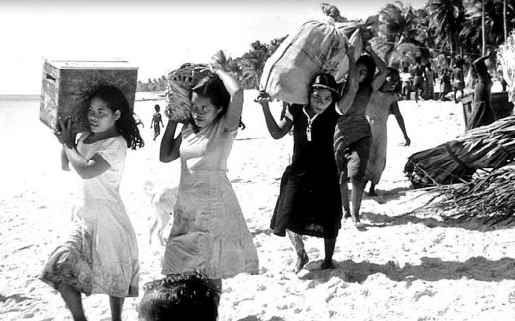 Bikini women load their belongings onto a waiting US Navy vessel in March 1946