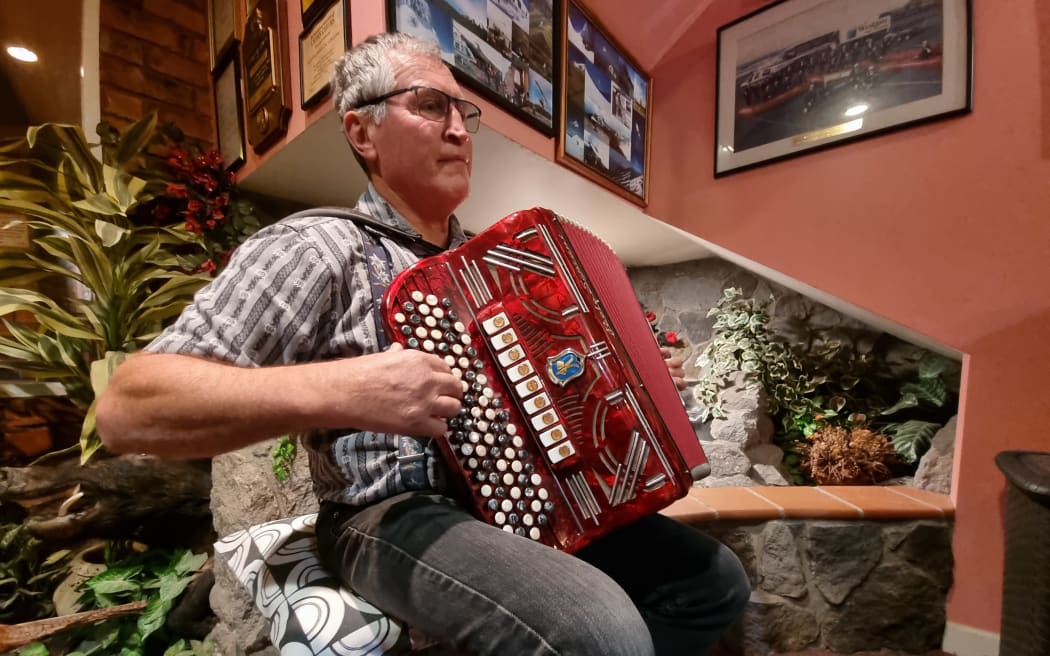 Othmar Hebler, the leader of the Taranaki alpine horn group, plays a piano accordion.