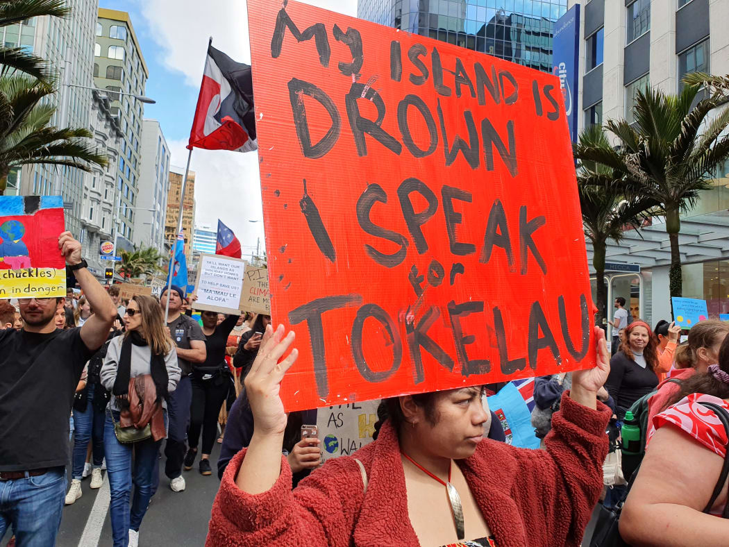 A Tokelaun woman brings her climate message to the Auckland rally.