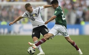 Germany's Joshua Kimmich (left) and Mexico's Hirving Lozano compete for the ball.
