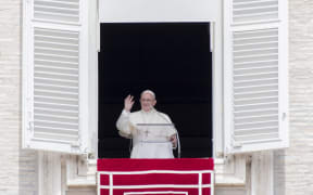 Pope Francis blesses the crowd during the Angelus noon prayer on August 15.