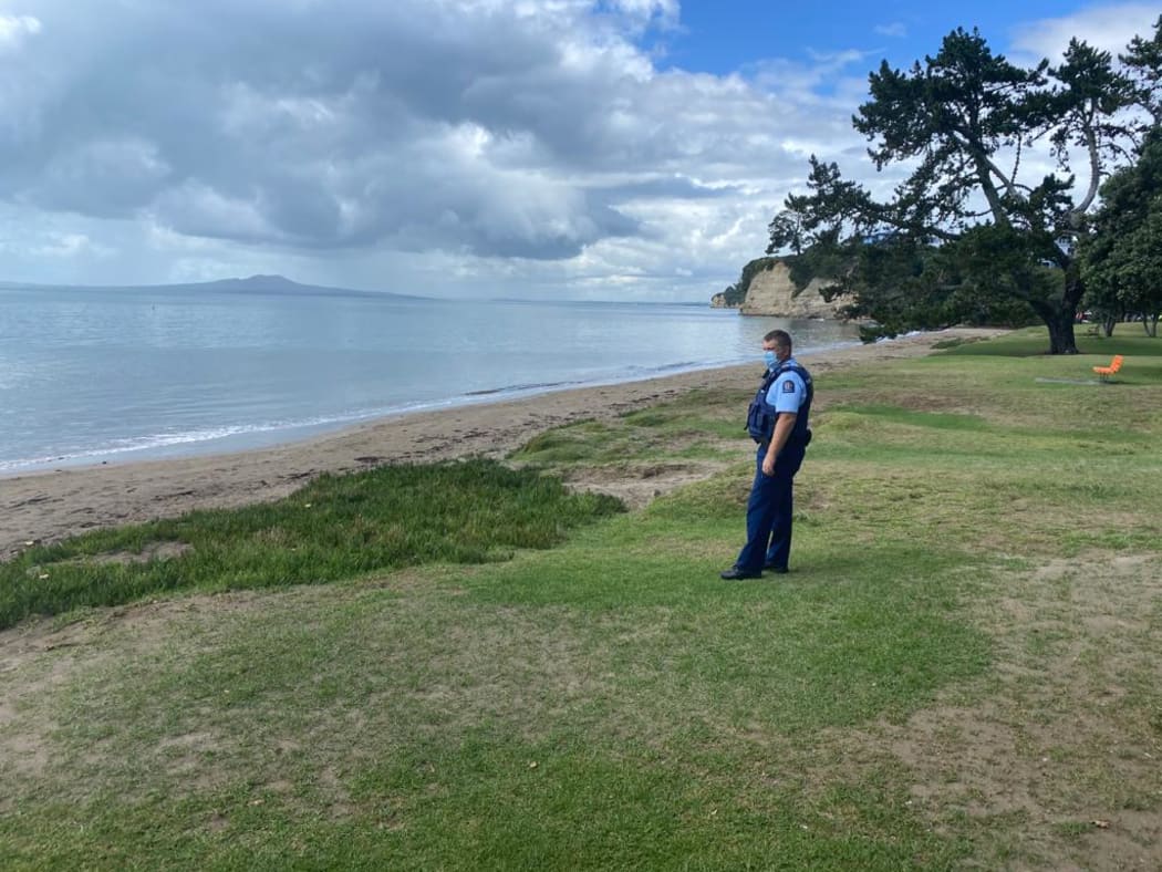 Police patrol a deserted Browns Bay in Auckland's North Shore.