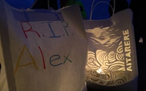 At the end of the vigil people lit candles in paper bags which were adorned with mesages of support in memory of Alex Fisher.