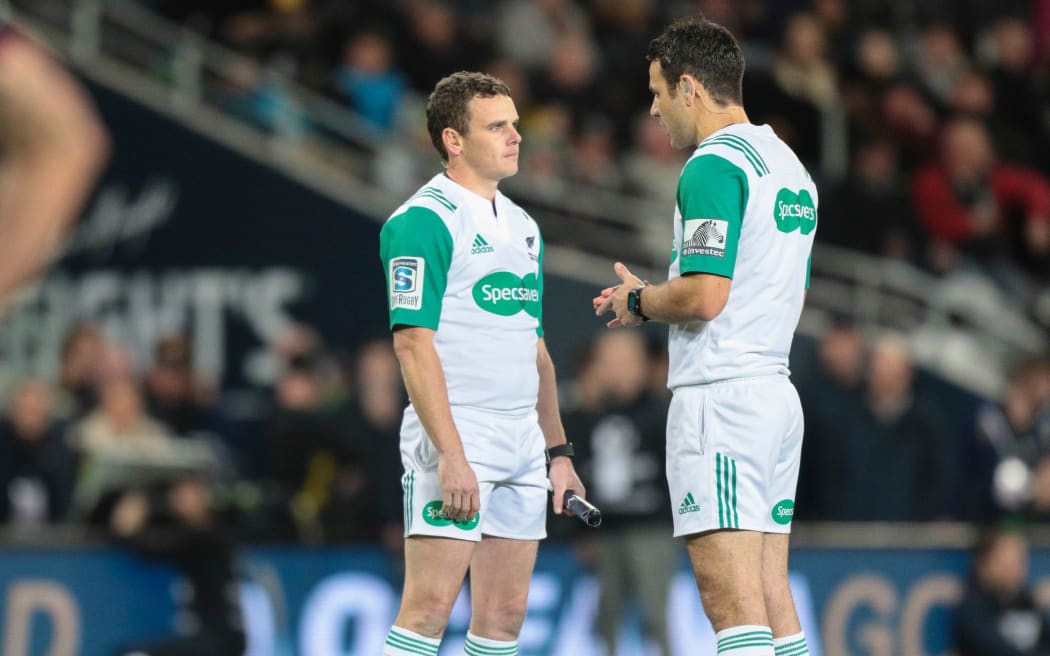 Referee Ben O'Keeffe, right, consults with assistant Mike Lash during a Super Rugby match.