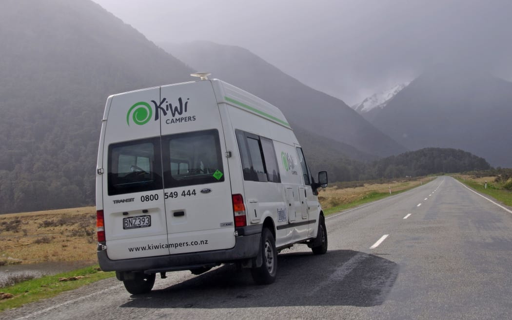 19777153 - west coast, new zealand, 2012-11-3:   a tourist's camper van approaches rainy weather surrounding the southern alps, westland, new zealand
