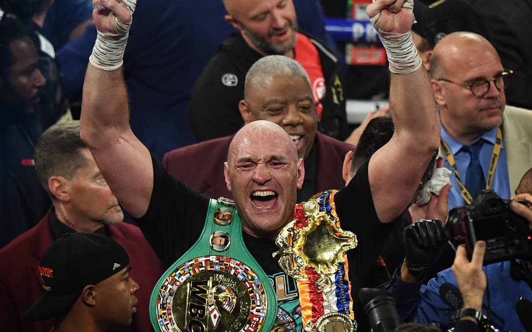 British boxer Tyson Fury celebrates after defeating US boxer Deontay Wilder in the seventh round during their World Boxing Council (WBC) Heavyweight Championship Title boxing match.